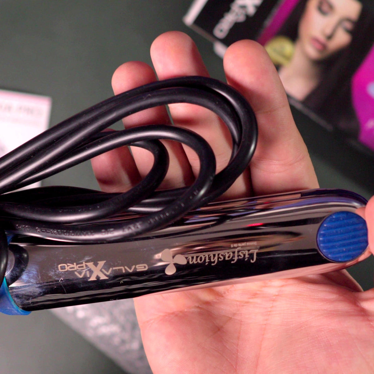 Plancha Lisfashion Galaxia Pro en mano con el cable enrollado y el grabado Lisfashion Galaxia X Pro